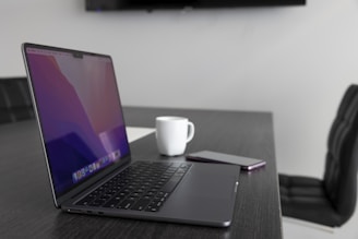 a laptop and a cup of coffee