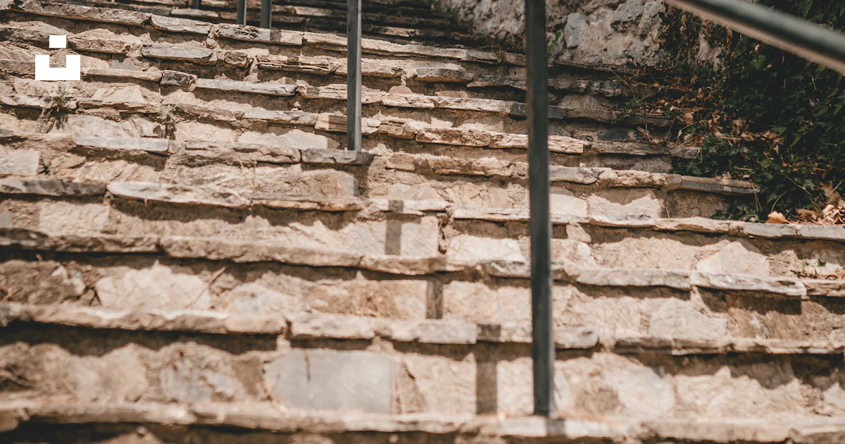 A stone wall with a railing photo – Free Handrail Image on Unsplash