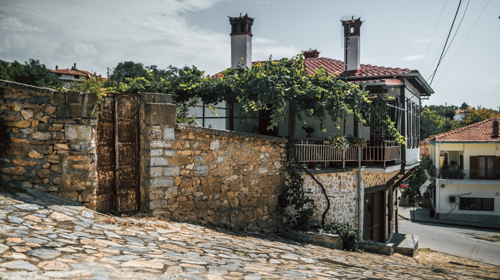 a stone wall with a stone fence and a stone wall with a brick building and a brick wall