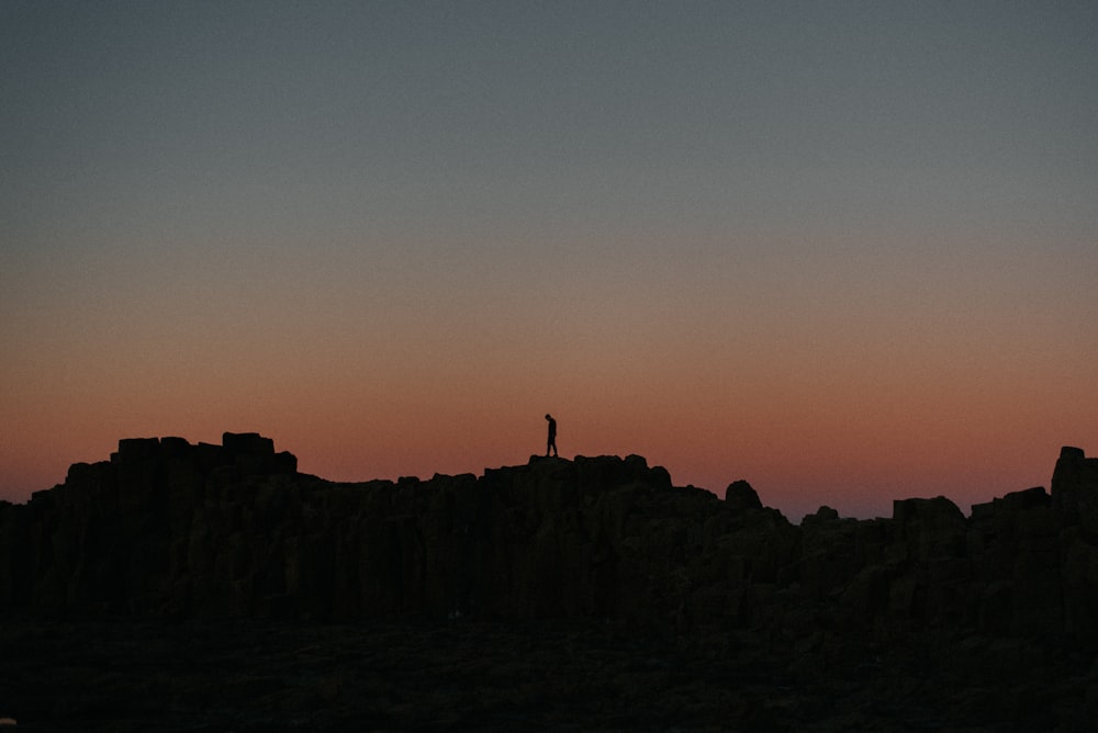 a person standing on a cliff