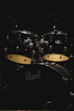 A modern drum set with cymbals in a bright, inviting room.