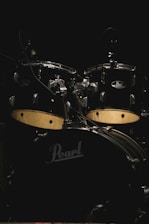 A vibrant display of finished drums and cymbals arranged in a workshop.