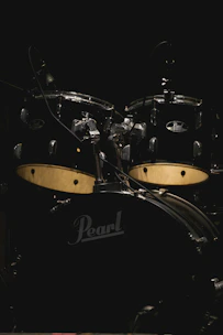 Various drum kits arranged elegantly against a black backdrop.
