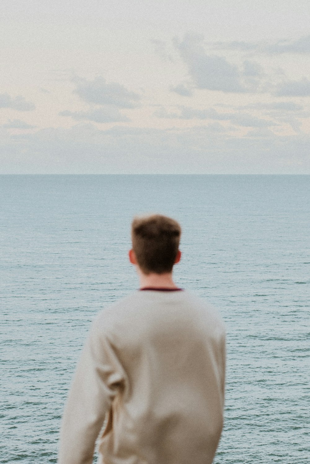 a man looking out over the water