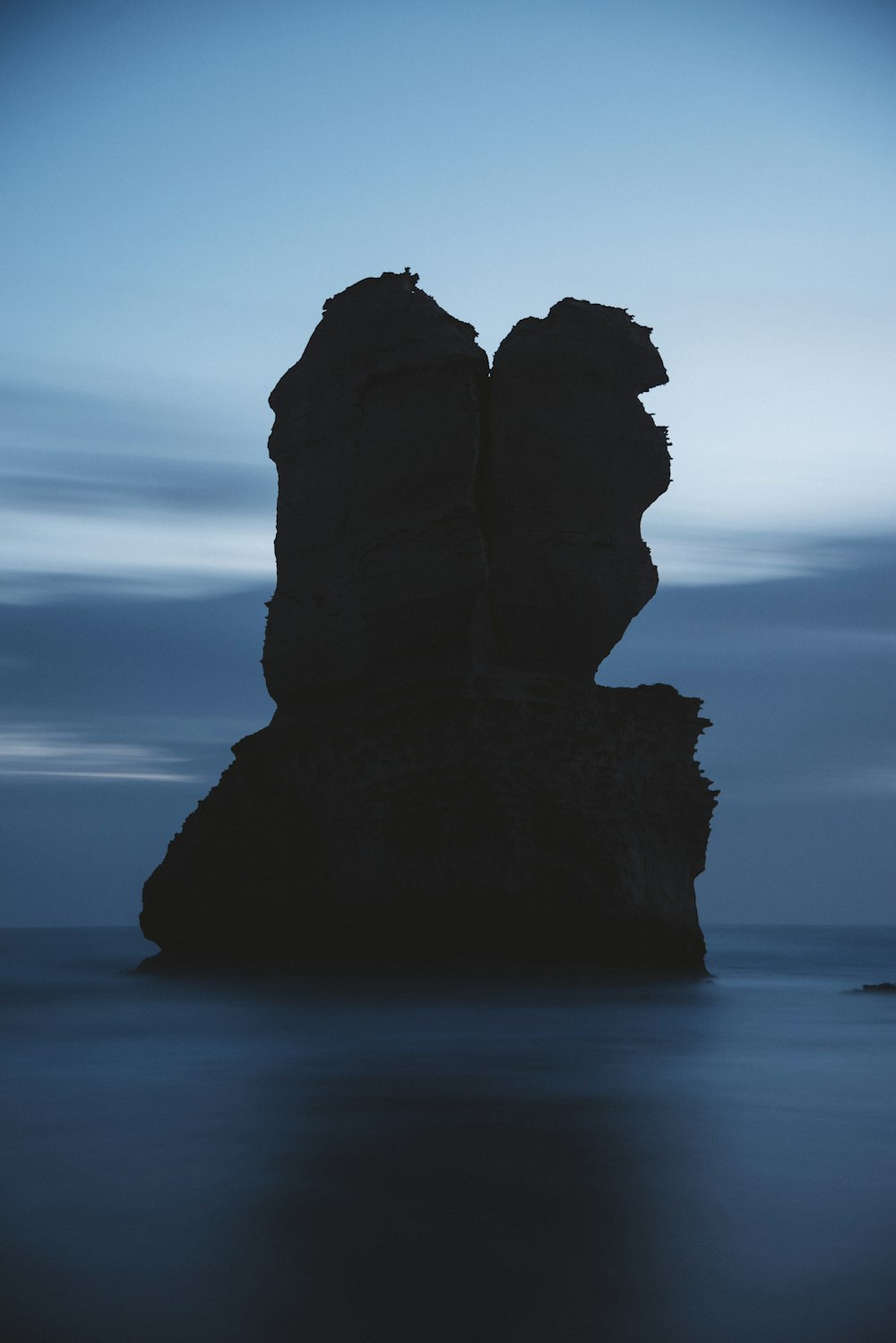 a group of large rocks in the water