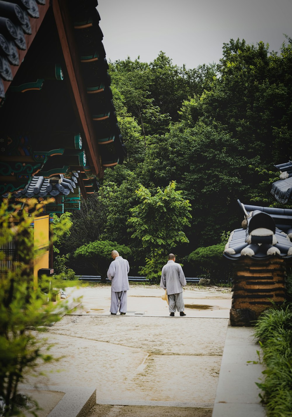 a couple of men walking down a sidewalk