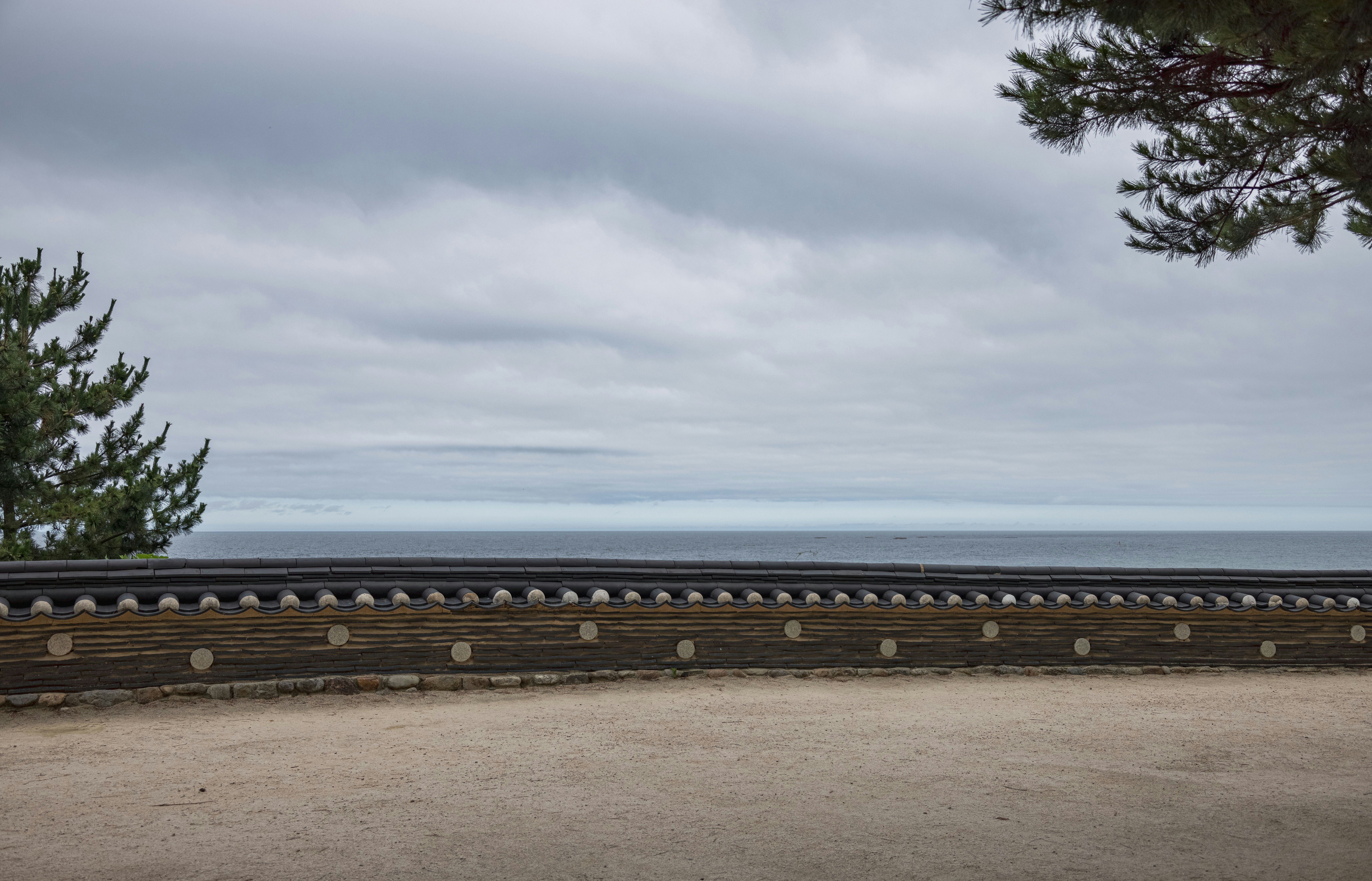 a wooden fence with a body of water in the background