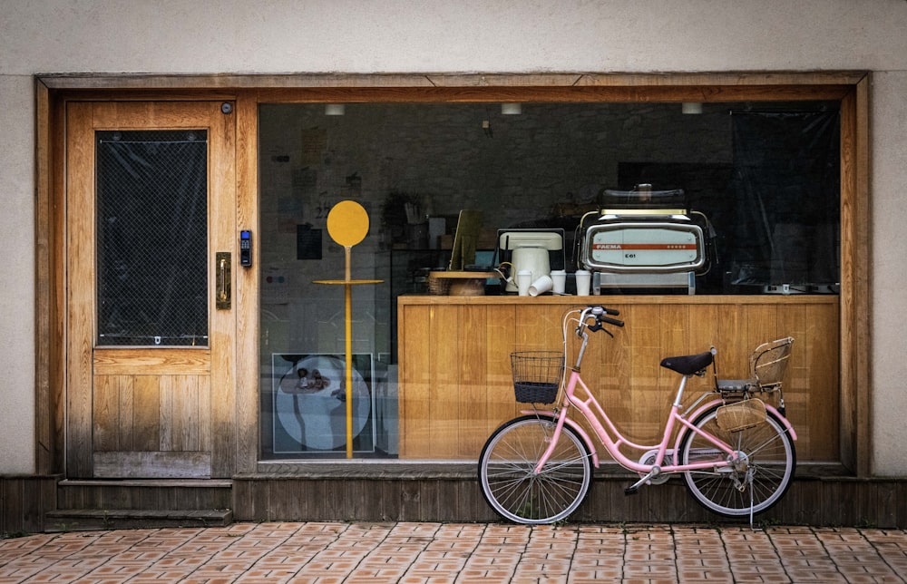 a bicycle parked in front of a window