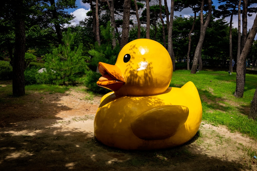 a large yellow rubber duck in a park