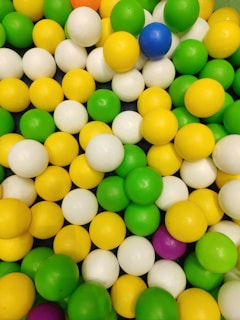 A playful arrangement of colorful rubber balls spilling out of a basket.