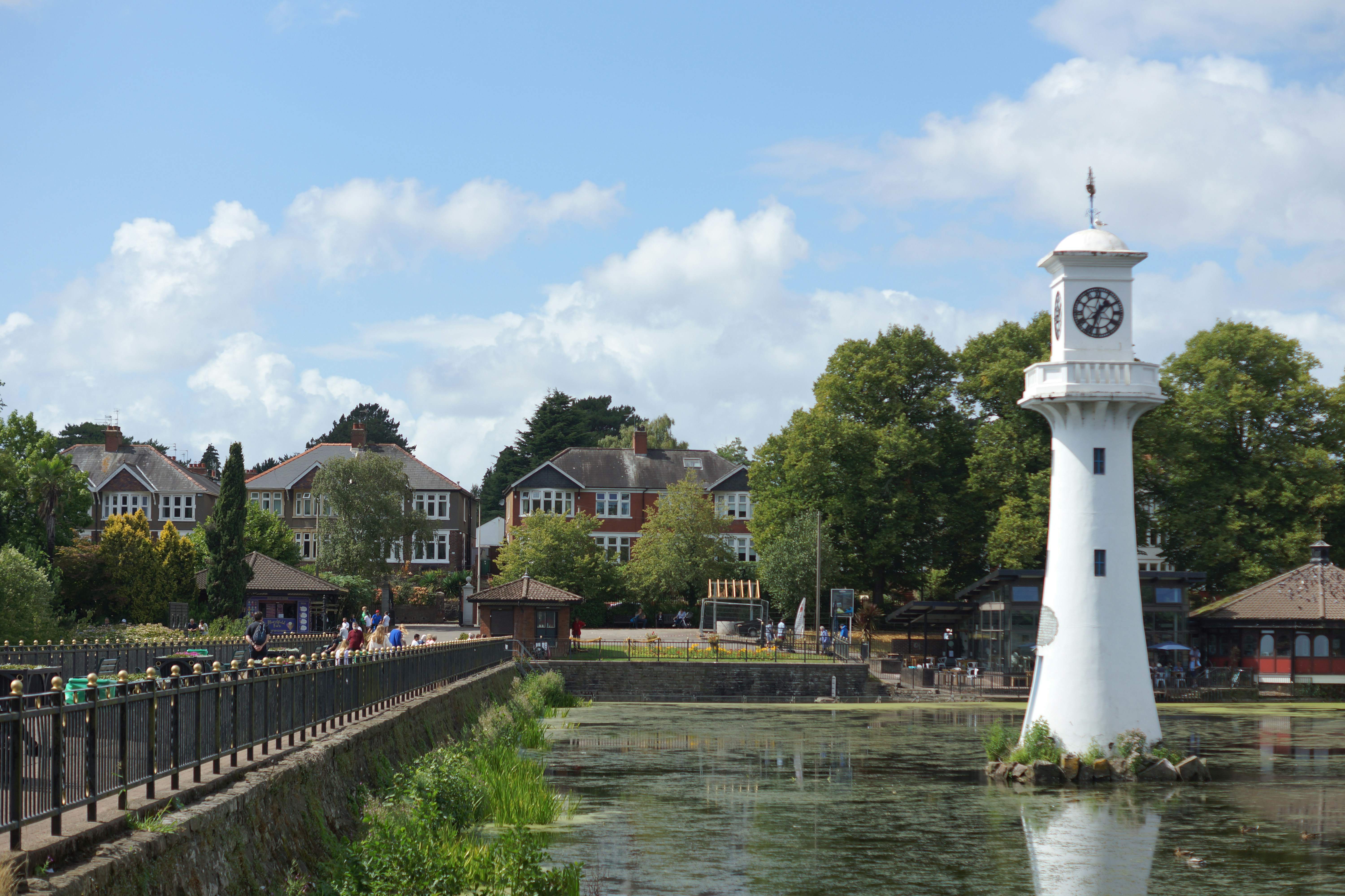 A clock tower next to a river photo – Free Roath park Image on Unsplash