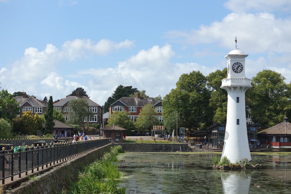 a clock tower next to a river