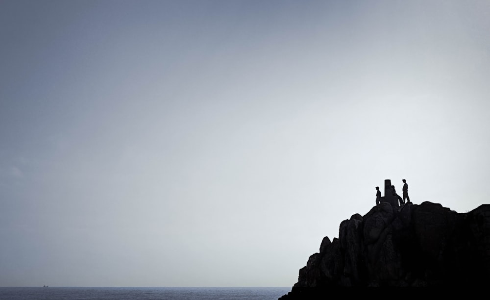 a group of people standing on a rock formation