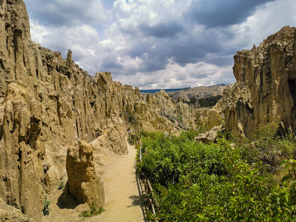 a dirt road between rocky cliffs