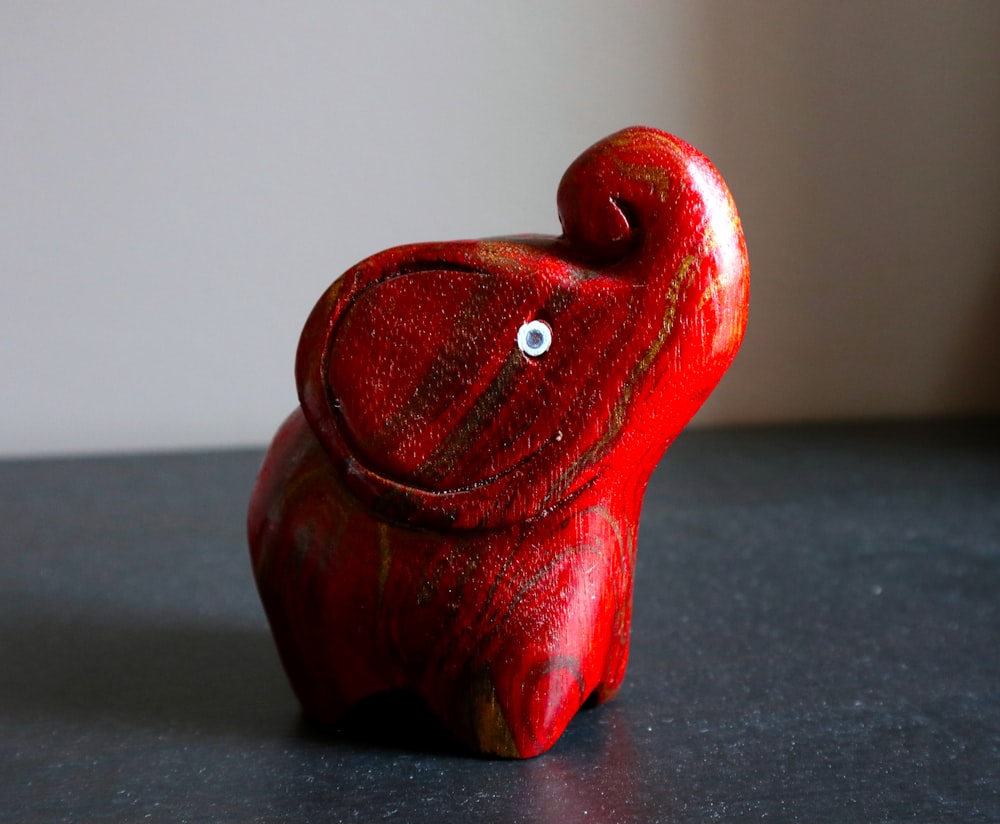 a red ceramic bird