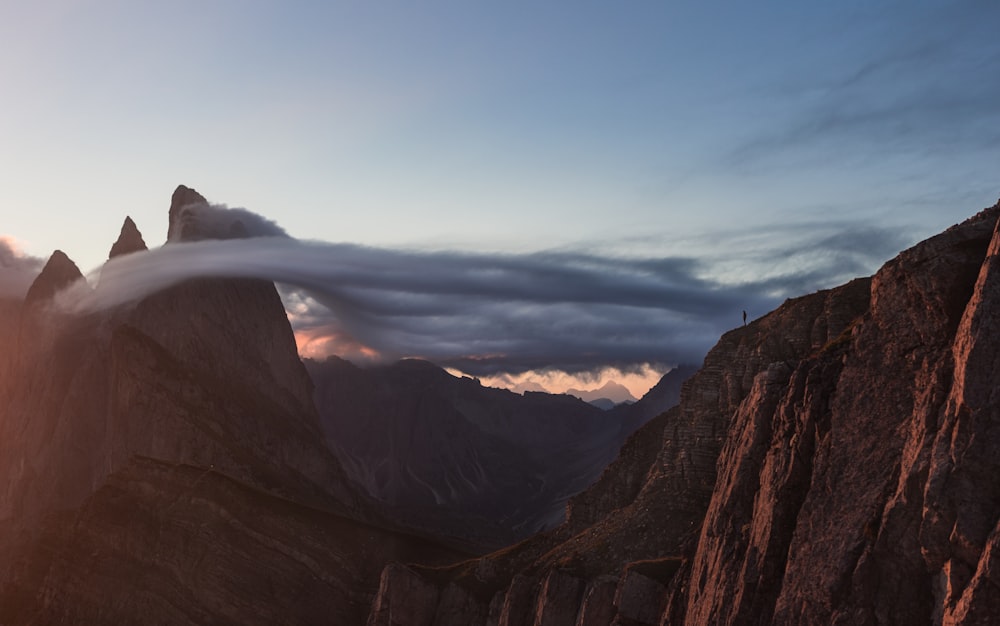 a rocky mountain with clouds