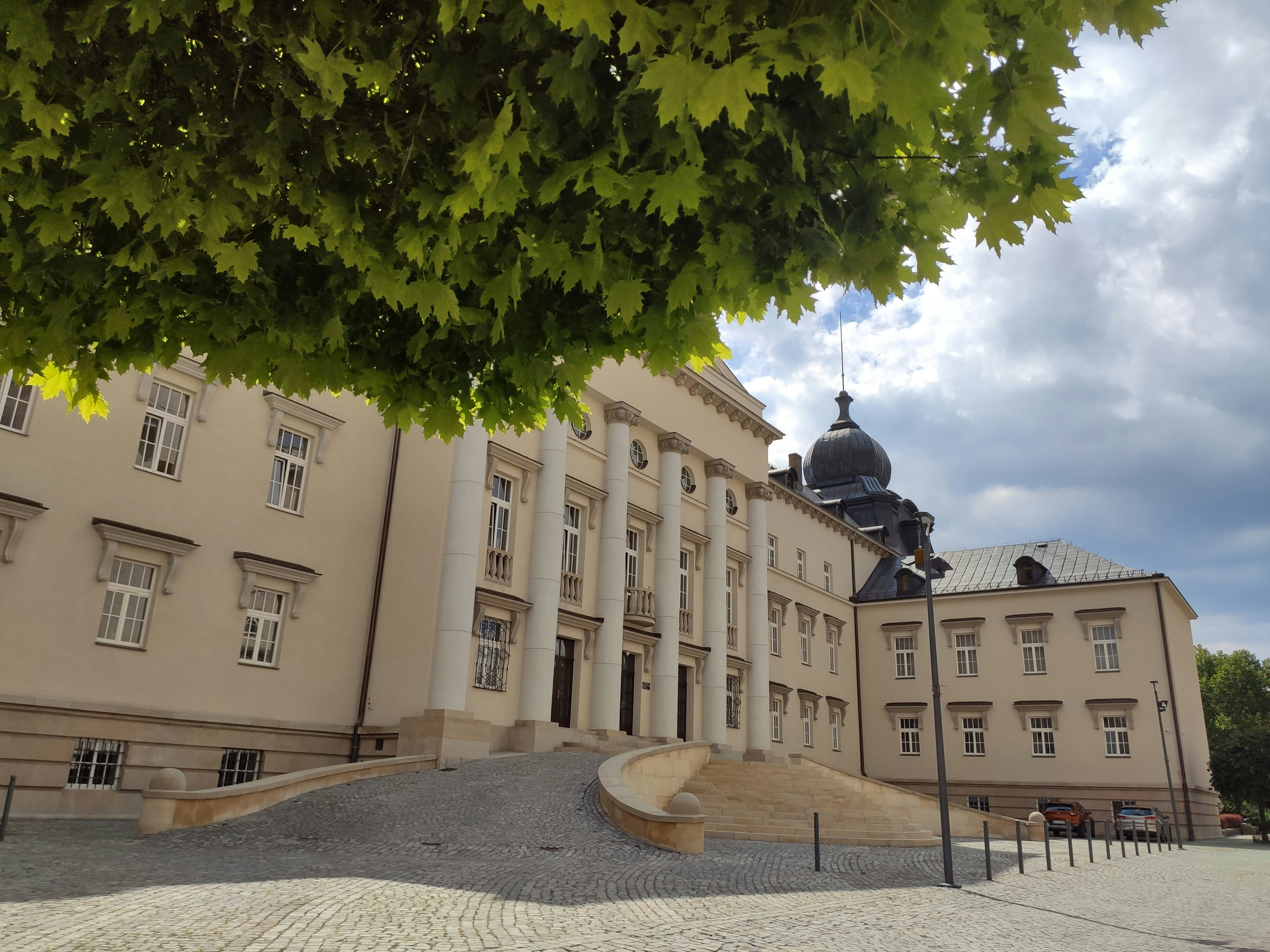 a large building with a tree in front of it