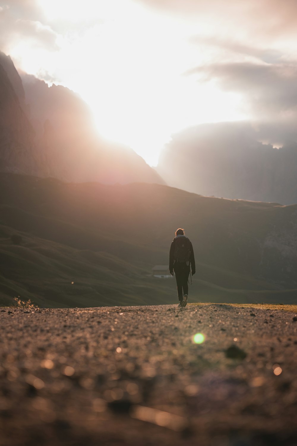 a man walking on a dirt path