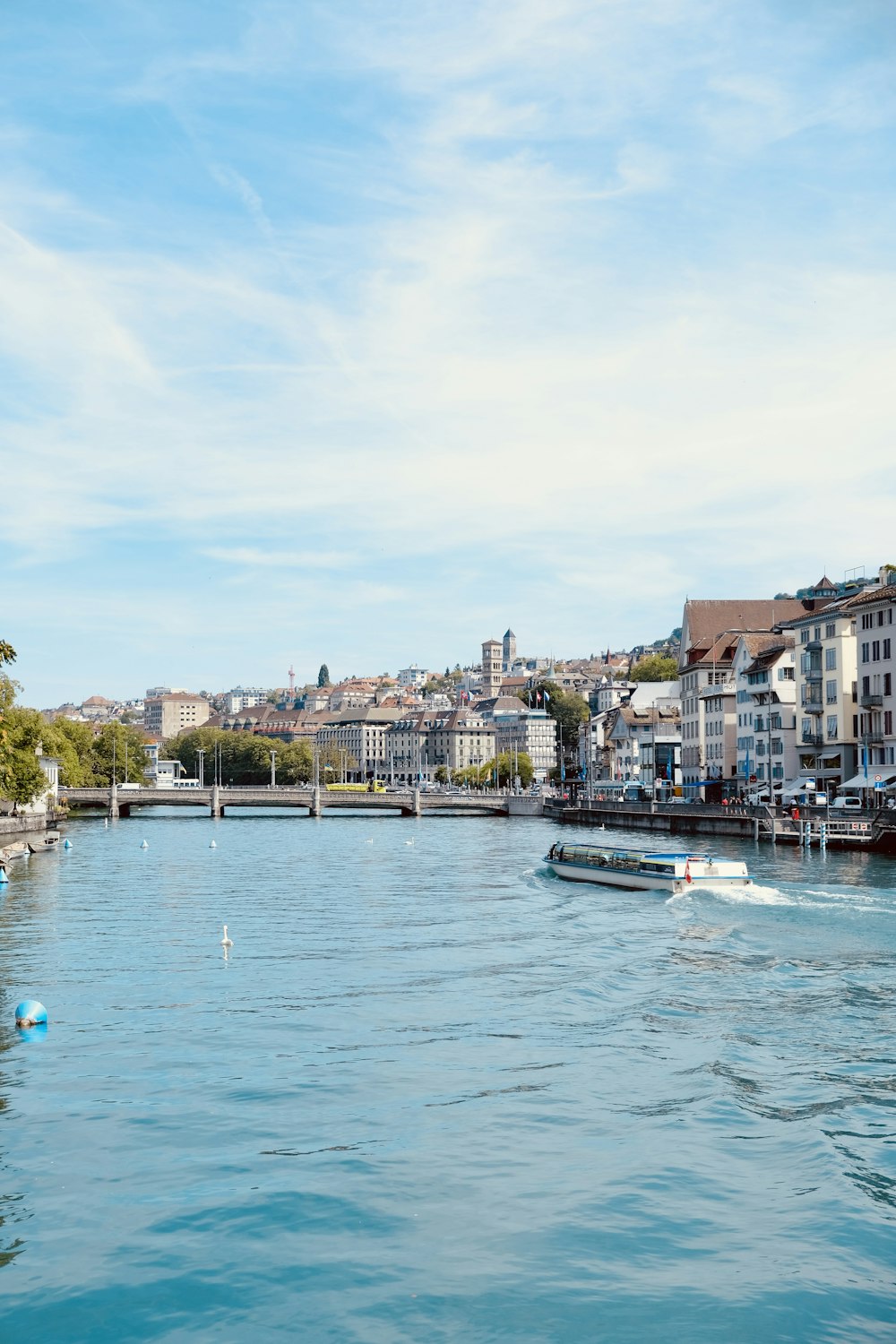 a body of water with boats in it and buildings in the back