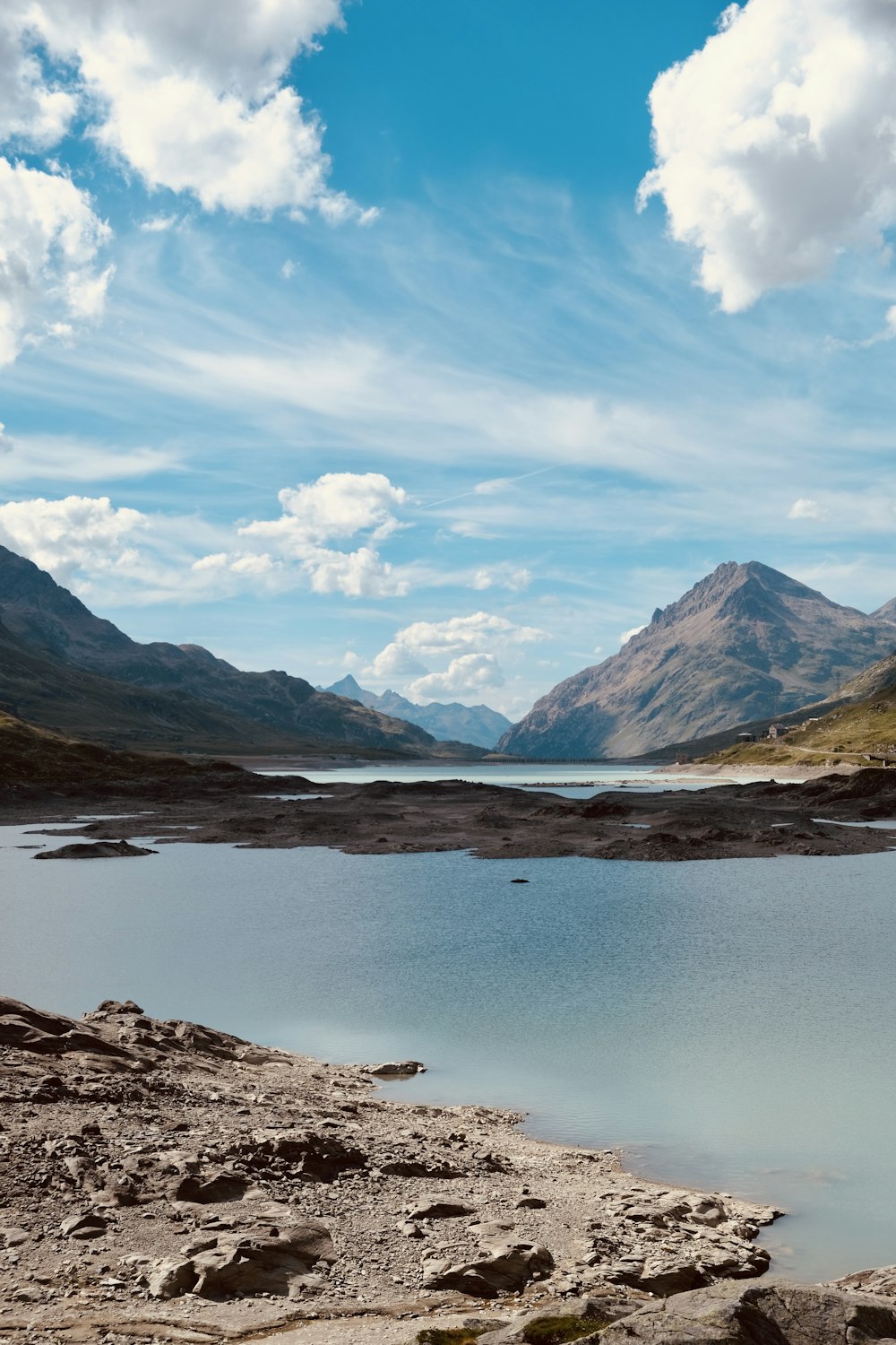 a body of water with mountains in the background