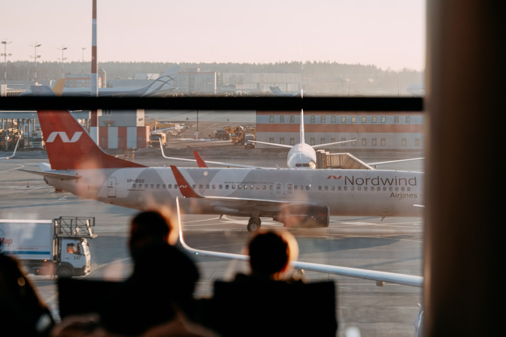 a group of people looking at an airplane at an airport