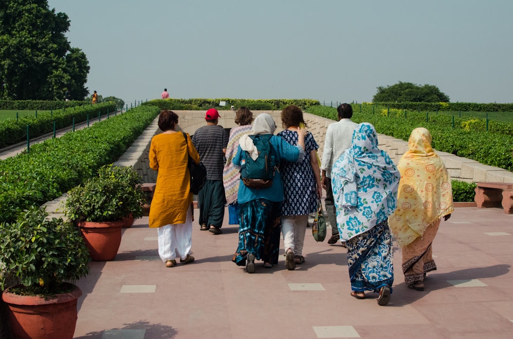 a group of people walking on a sidewalk