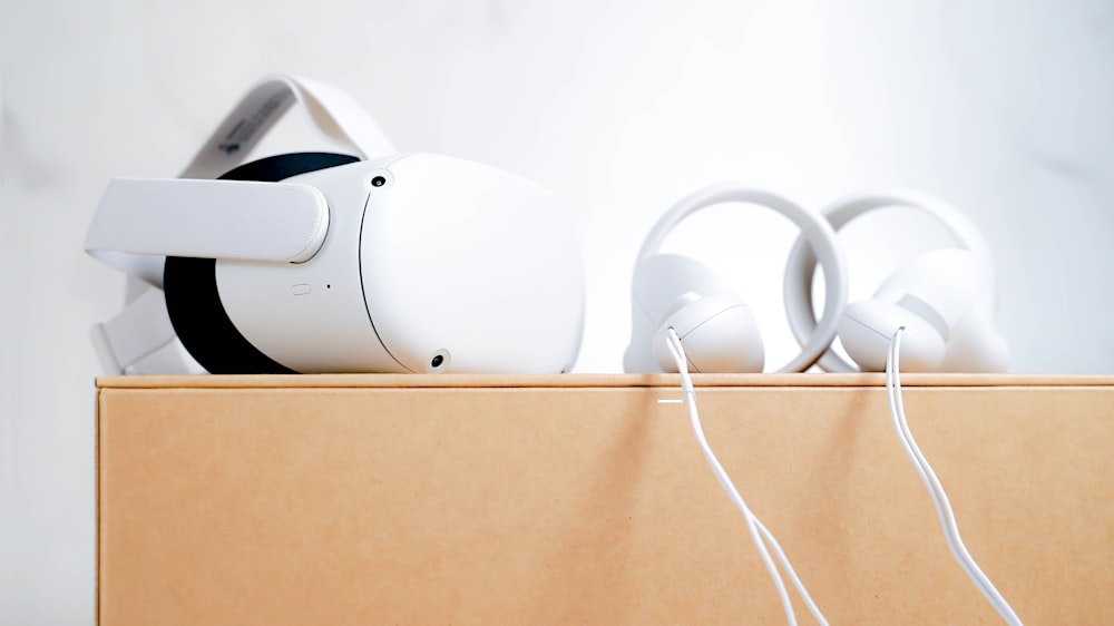 a pair of white headphones on a box
