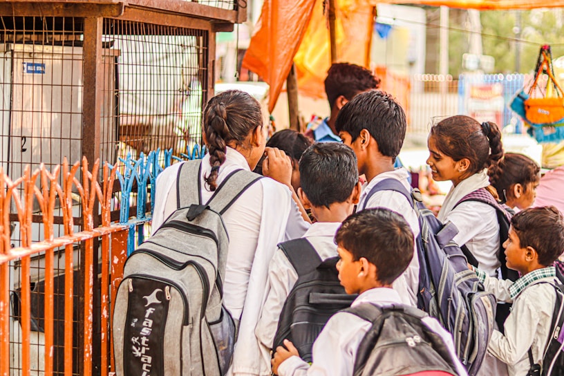 A group of cheerful school children proudly wearing crisp, colorful uniforms from Gurukripa Uniform Store.