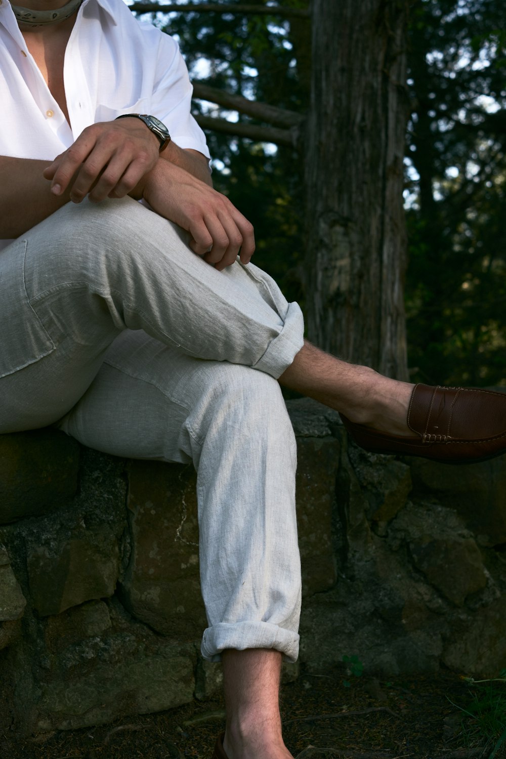 a man sitting on a rock