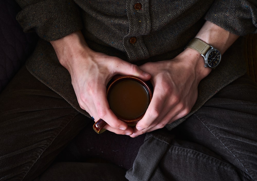 a person holding a cup of coffee