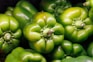 a close up of a group of green peppers