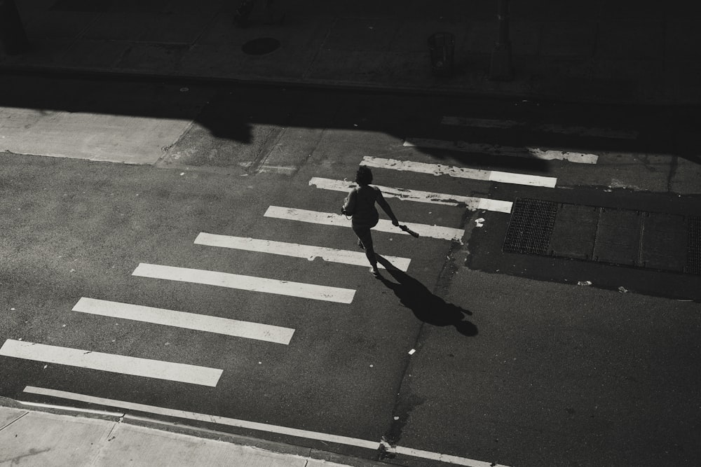 a person walking across a crosswalk