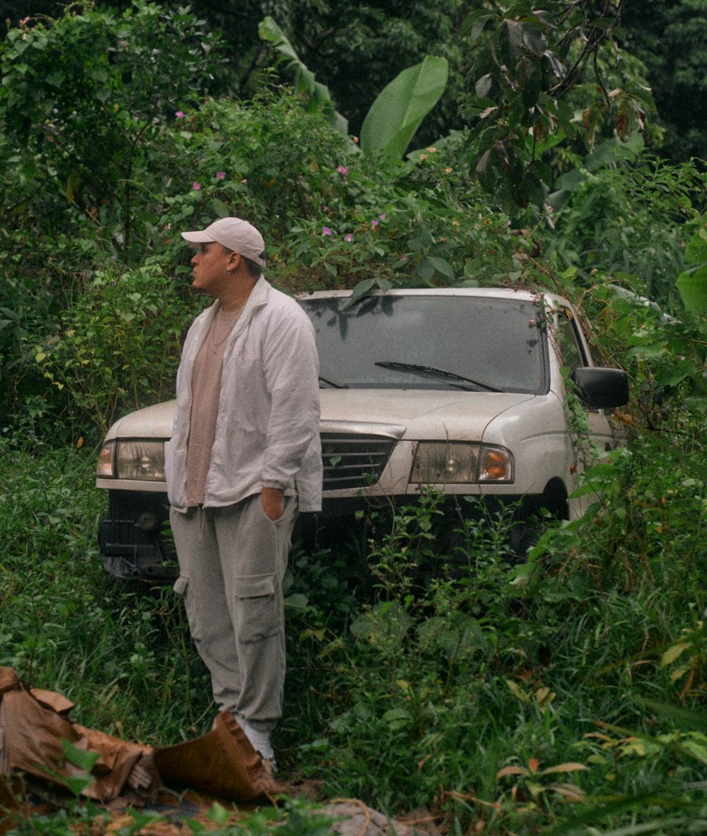 a man standing next to a car