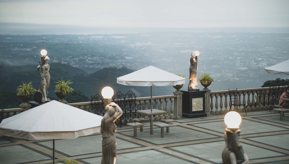 a group of statues on a balcony