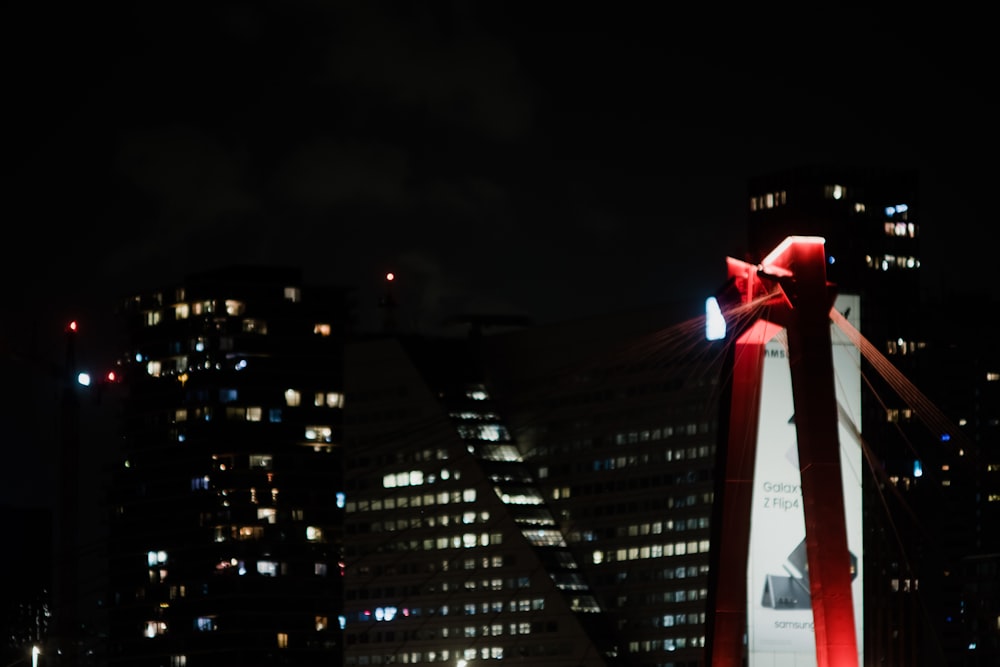 a flag on a pole in front of a city at night