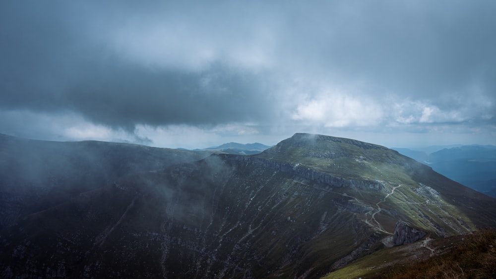 a valley with mountains in the background