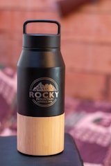 a black bottle with a brown cap