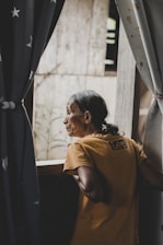 a man leaning against a fence