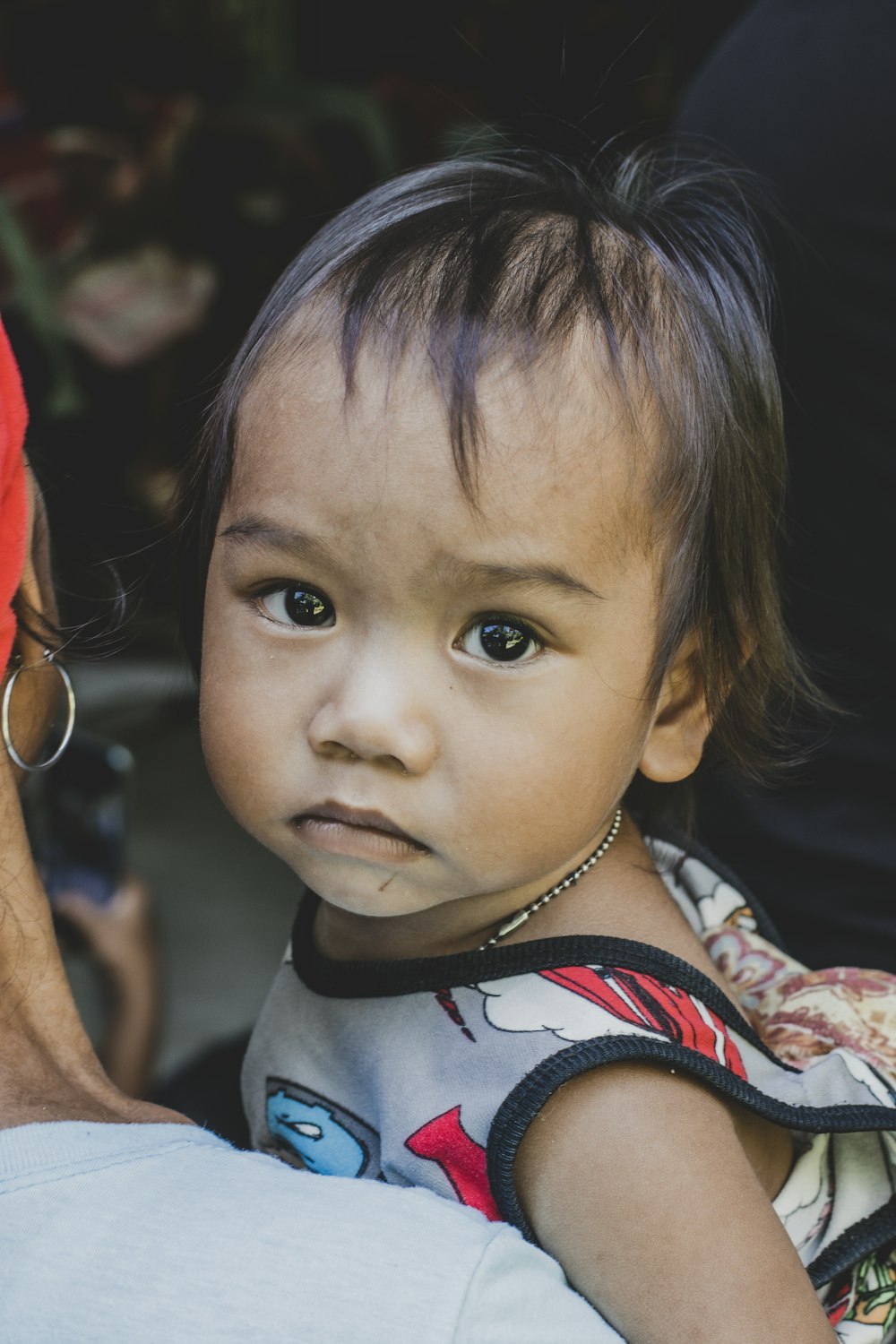 a young girl with a necklace