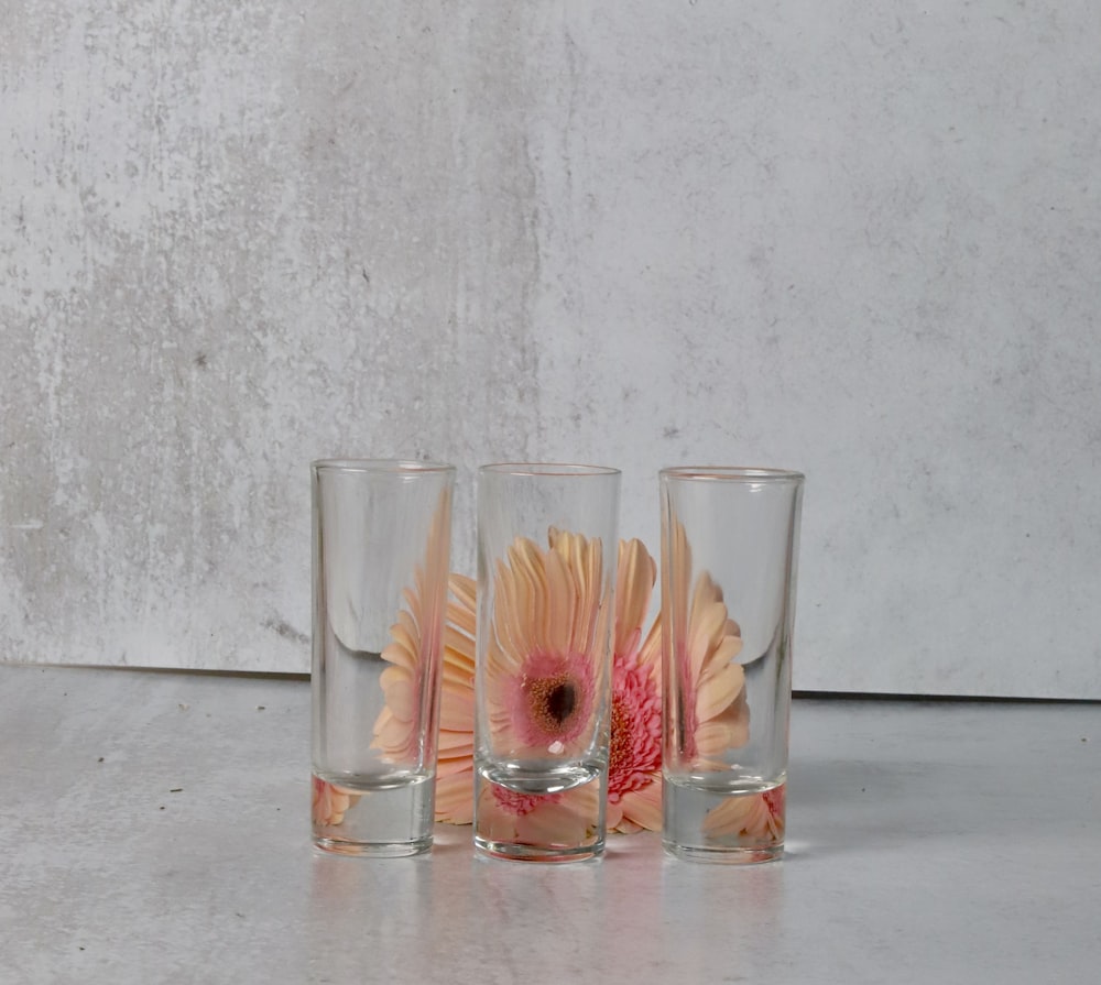 a group of glass cups with liquid in them