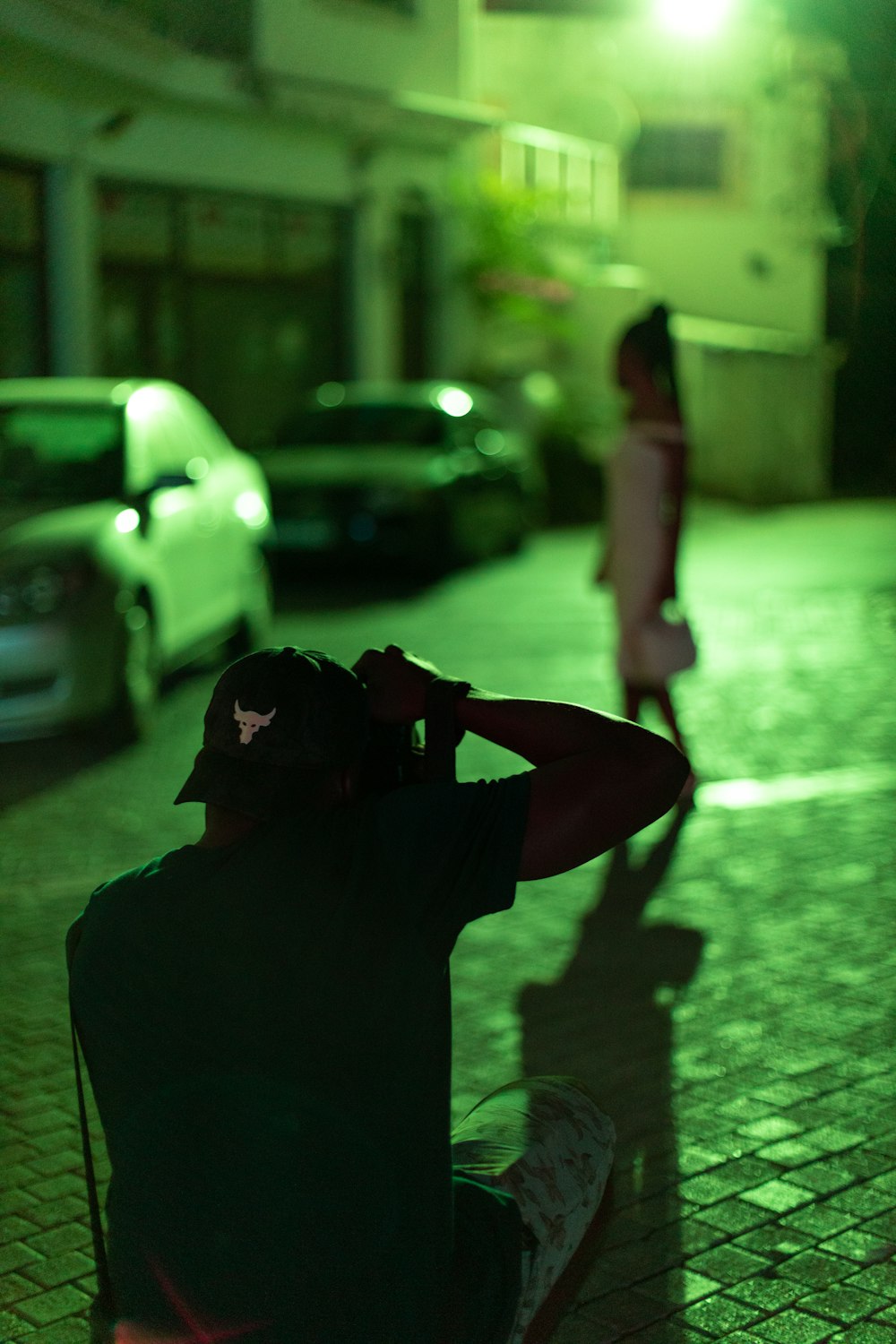 a man taking a picture of a woman on a sidewalk