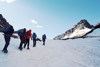 a group of people standing on a snowy mountain