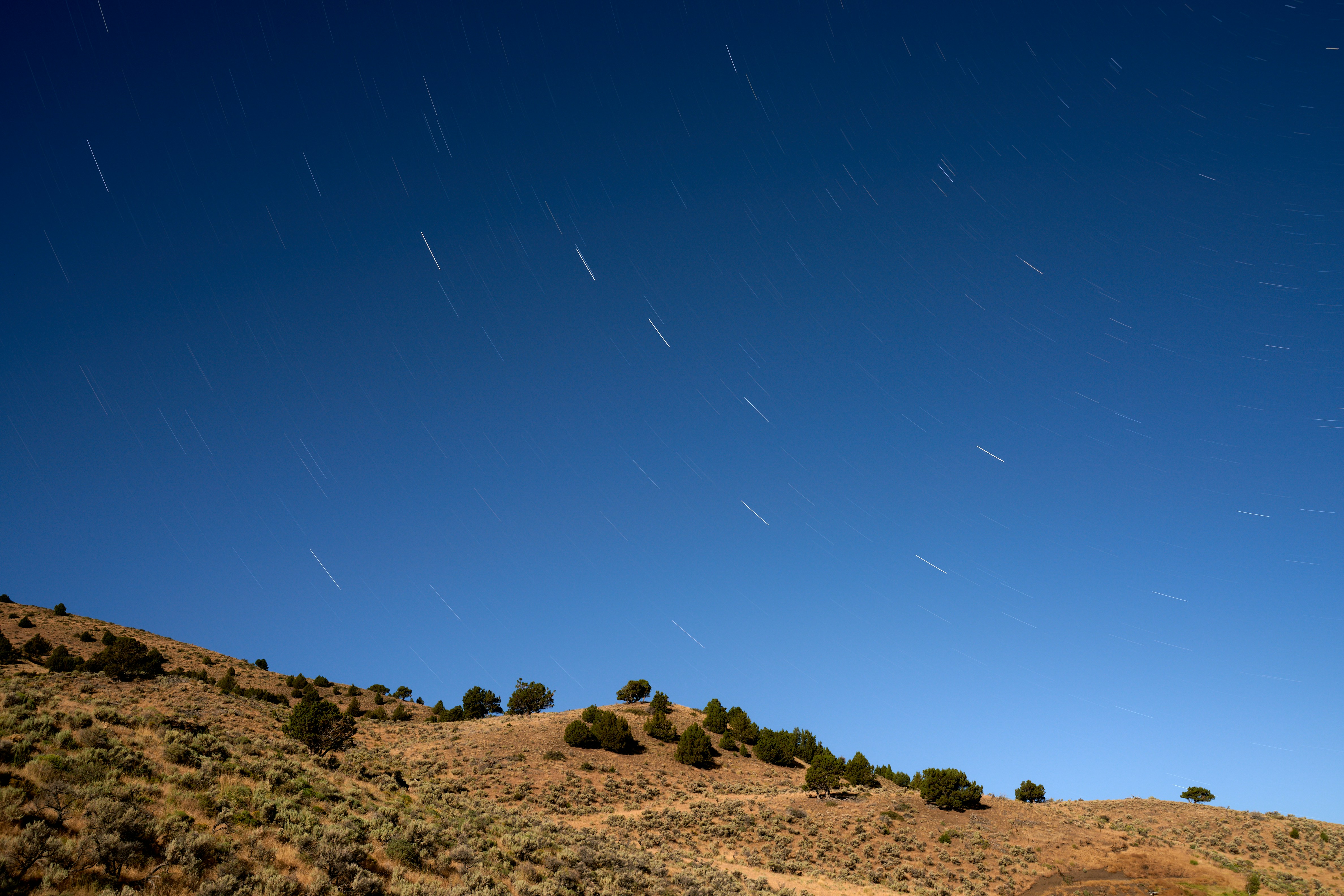 a landscape with a hill and blue sky