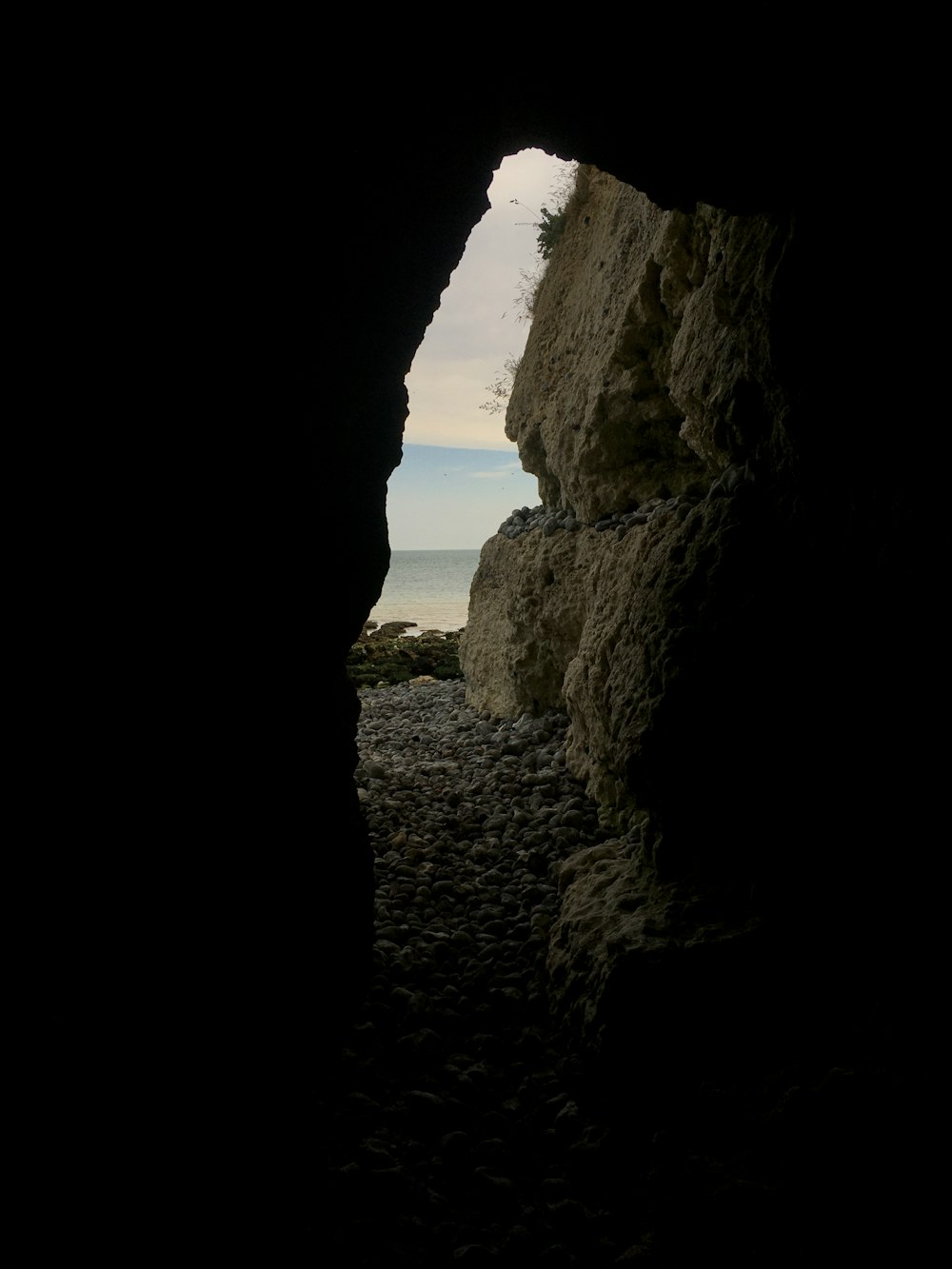 a view of the ocean through a cave