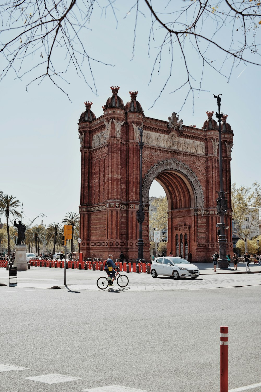 a large stone arch with a person riding a bicycle