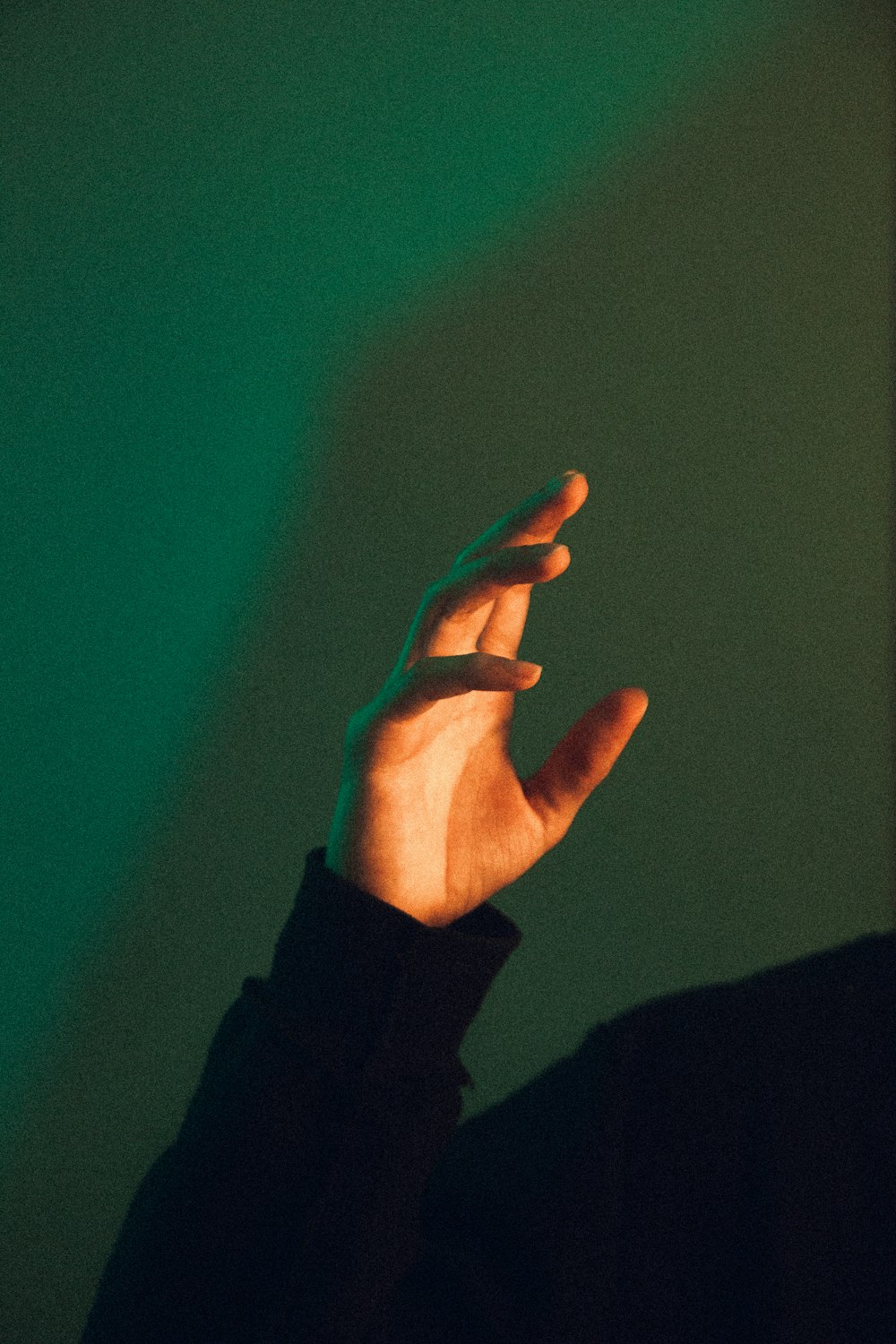 a hand with a green background