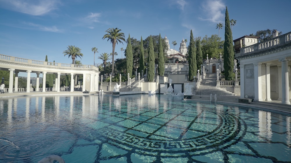 a pool with Hearst Castle in the background