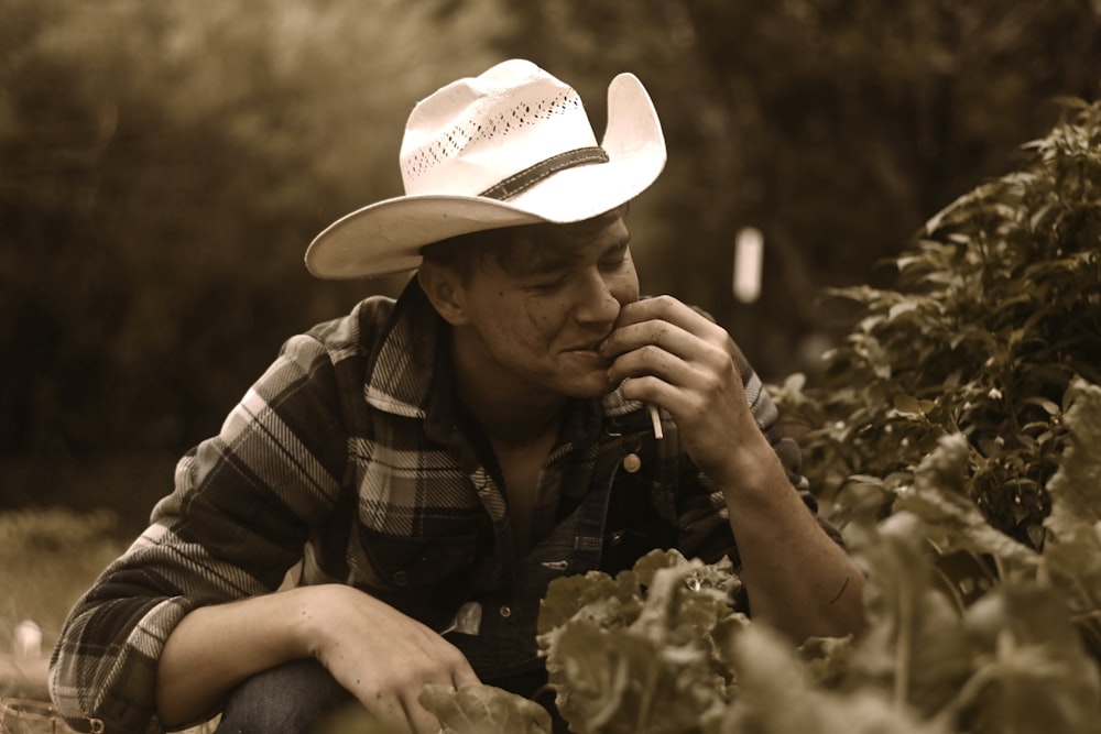 a man in a hat smoking a cigarette