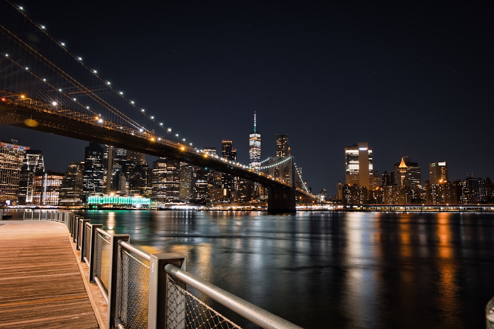 a bridge over a body of water with a city in the background