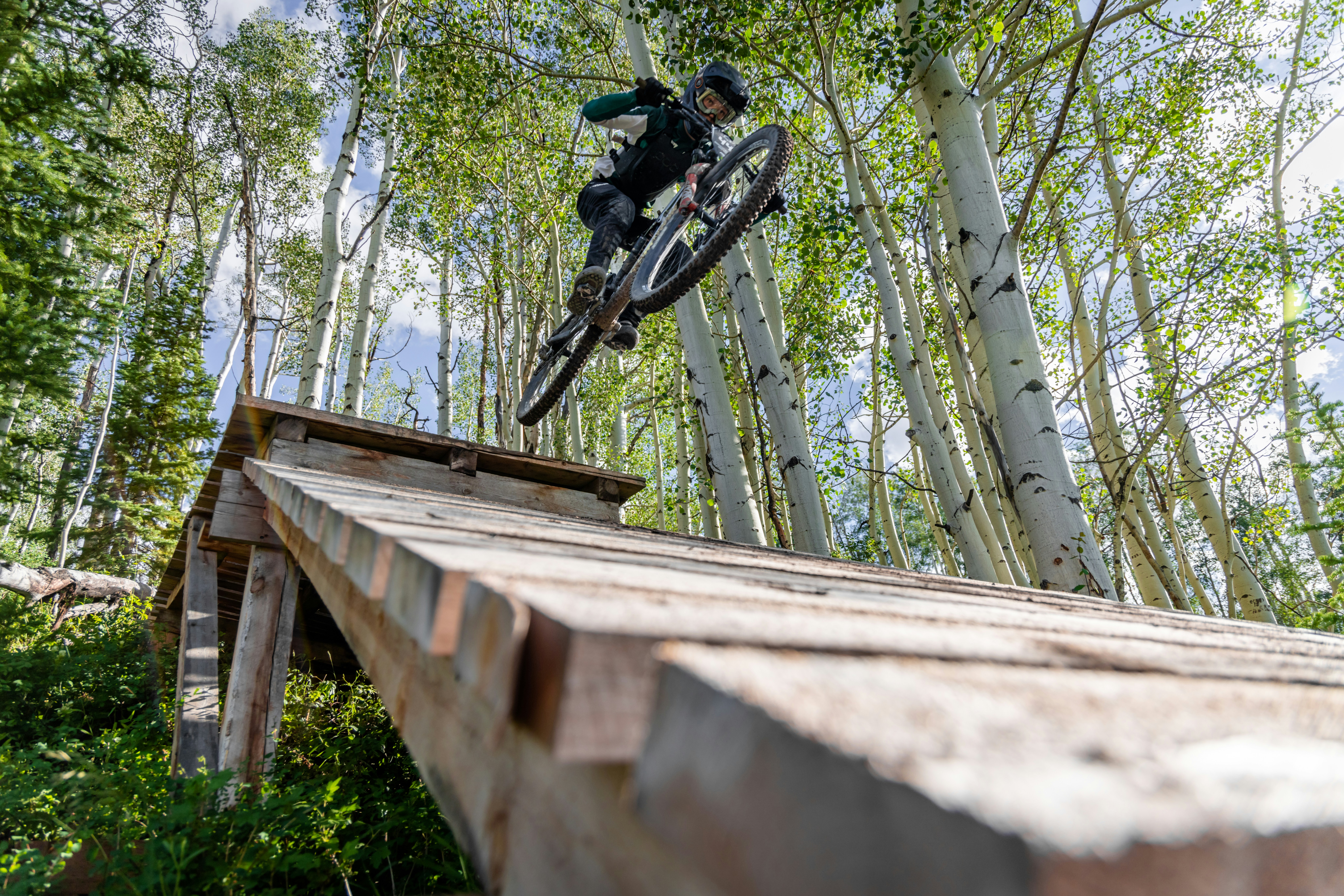 A person jumping a bike over a ramp photo – Free Grey Image on Unsplash
